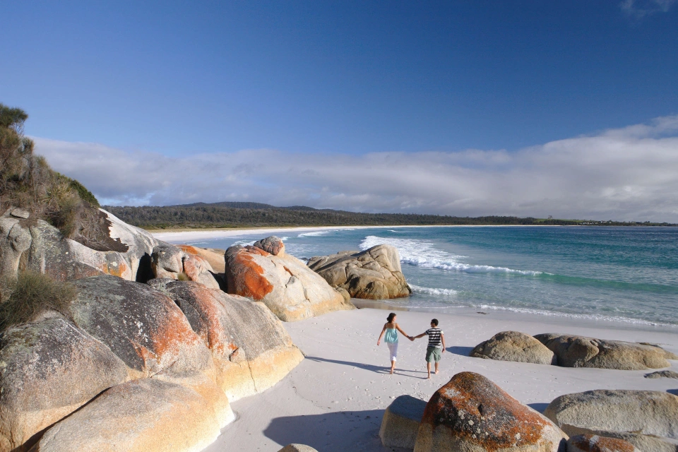 Beach couple walking warm mixed pair2